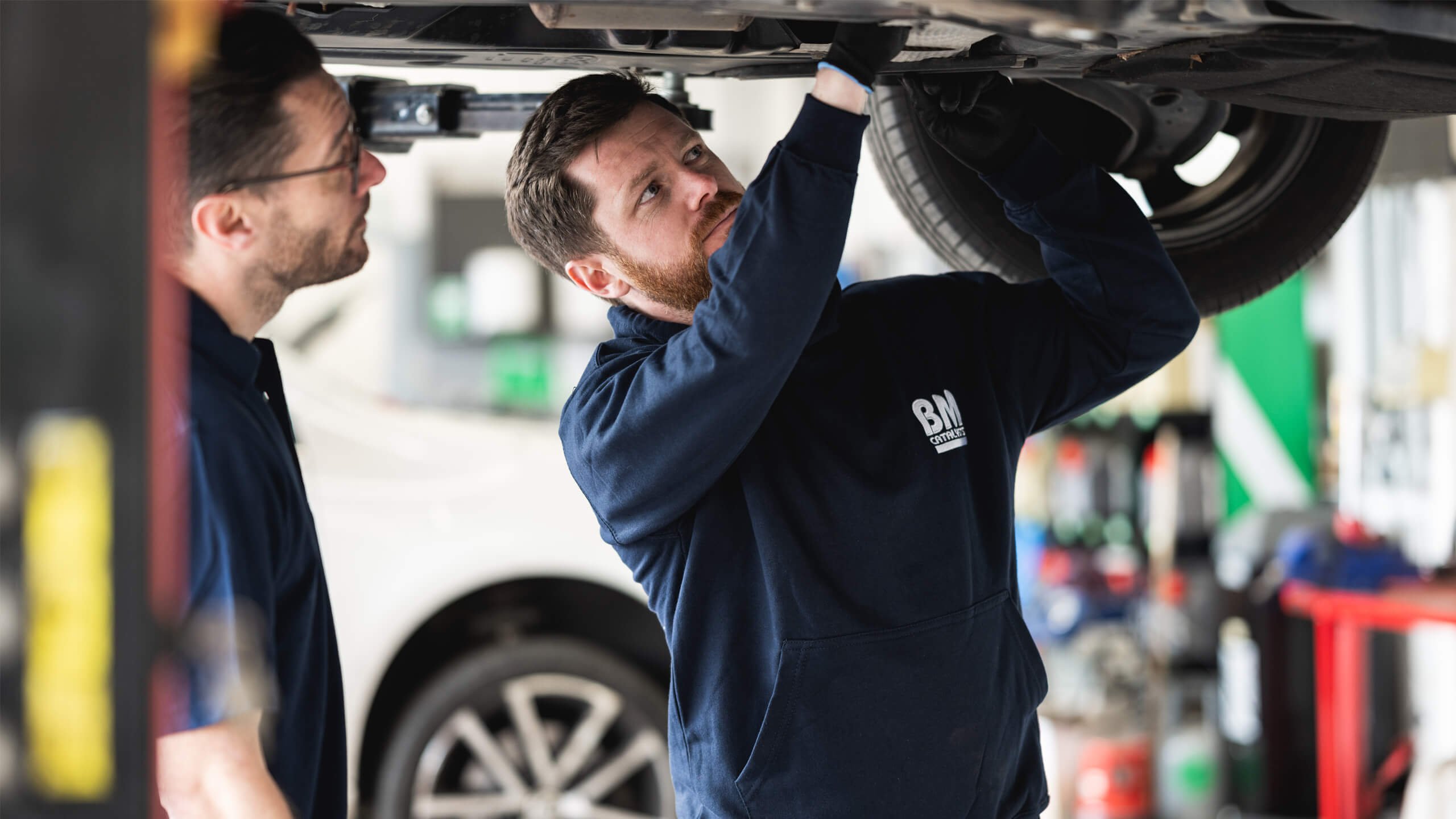 BM Garage Employees inspecting underneath car