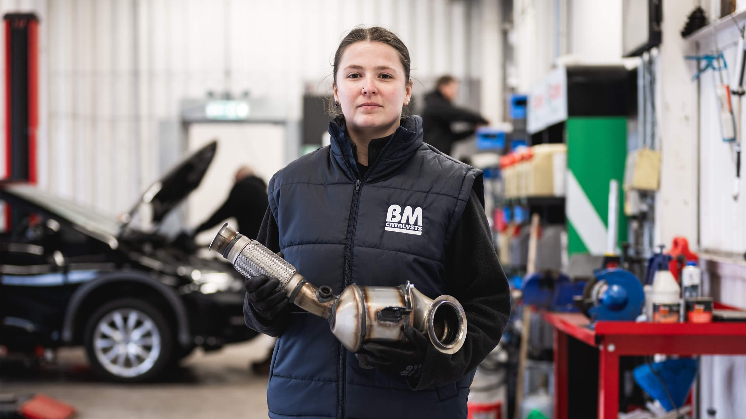 BM Garage employee holding part